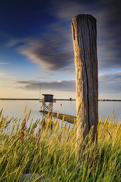 beautiful sunset behind a fisherman's house at the waterfront in Scharendijke in the province of Zee by gaps photography