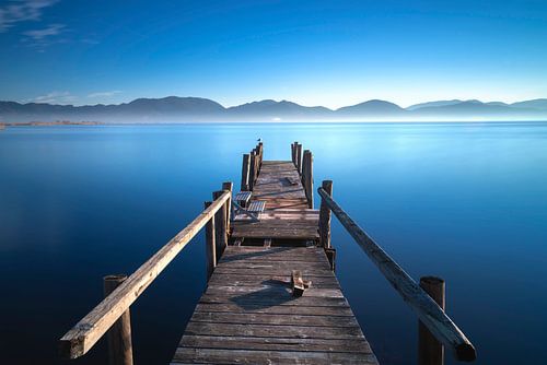 Houten pier bij zonsopgang. Massaciuccoli meer, Toscane, Italië