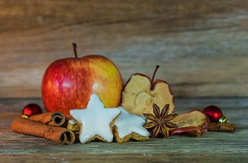 Christmas food composition with red apple fruit, star shaped biscuits, spices by Alex Winter