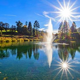 Double sunshine and fountain in Lake Reitecksee by Christa Kramer