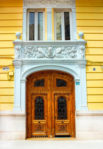 Old Spanish Wooden Front Door with Yellow Gable Photo - Authentic Wall Decoration Valencia