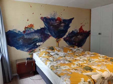 Three blue, long-stemmed poppies on a meadow