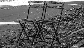 Two street chairs (widescreen photo) [monochrome]. by Norbert Sülzner