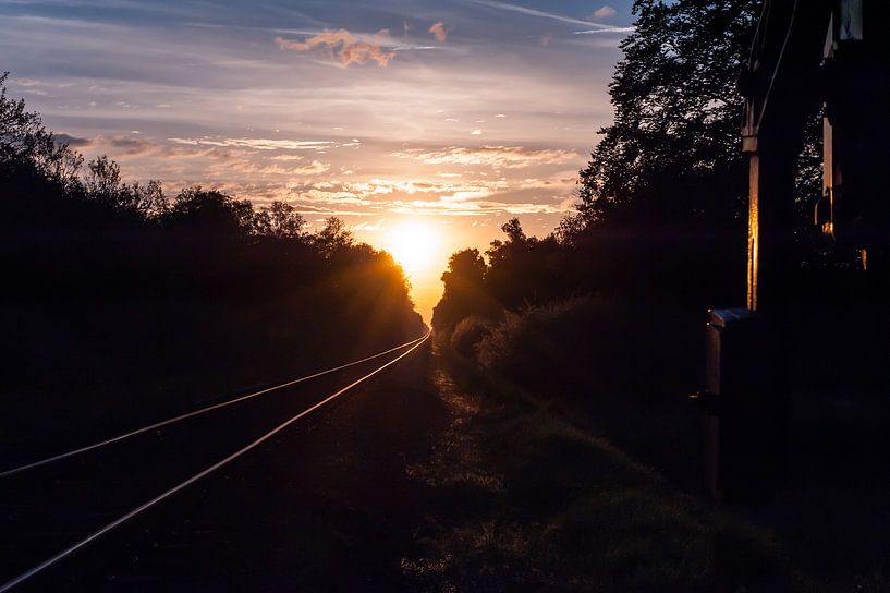 Sunset at the railroad by Robert de Jong