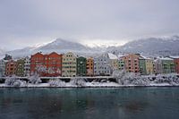 Colorful snowy houses in Innsbruck at the river Inn (Tyrol, Austria)