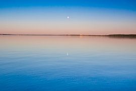 The turquoise lake at dawn. smooth blue and turquoise lake surface at dawn, red and orange and sky b by Michael Semenov