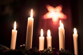 Burning candles on the table by Wouter Kouwenberg