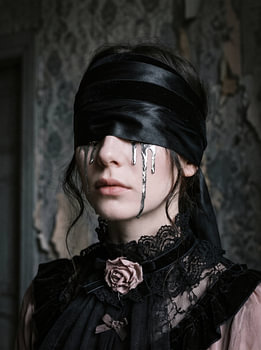 Silver Tears Beneath a Black Blindfold