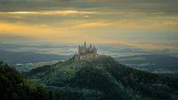 Hohenzollern Castle on a hill with a sunset landscape