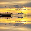 Boats on Wadden Sea with perfect reflection. by Justin Sinner Pictures ( Fotograaf op Texel)