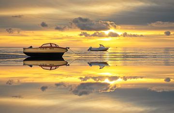 Boats on Wadden Sea with perfect reflection.