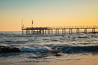 Jetty in sunset by the sea