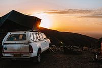Sunrise with car and rooftop tent on the Brukkaros volcano, Namibia