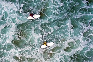 Top shot of 2 surfers in the sea by Eye on You