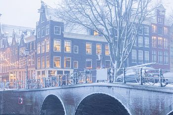 Snow-covered bridge with Christmas lights in Amsterdam