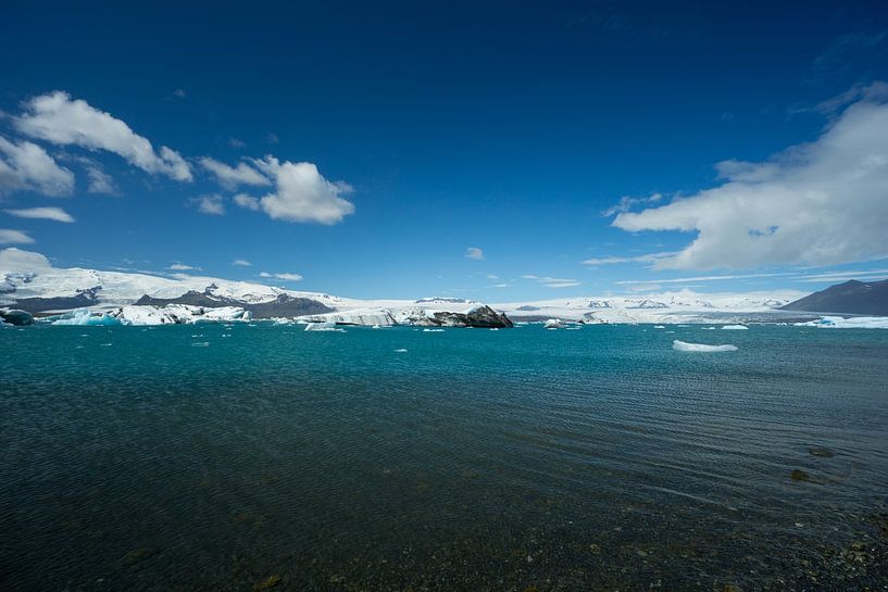 Iceland - Blue sky over agitated turquoise clear water of glacial lake Jökulsárlón by adventure-photos