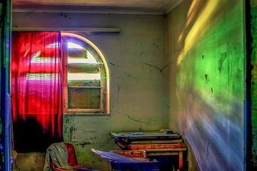 The light breaks on the basement window of an abandoned house. by Marcel Hechler