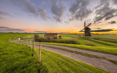 Dutch Wooden windmill under beautiful sunset sky