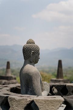 Buddha statue from the 8th century, at the Borobudur temple complex - Java, Indonesia by Tim Loos