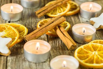 Burning Christmas and Advent candles with aromatic decoration by Alex Winter