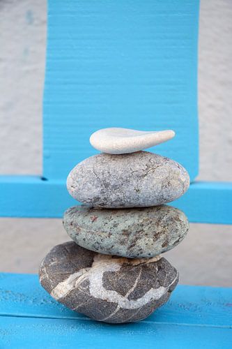 Zen pile of stones and boulders with an old background
