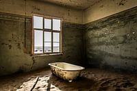 Verlassenes Badezimmer in einer Geisterstadt voller Sand