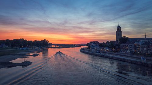Boat sails in the IJssel along the skyline of Deventer