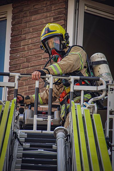 Firefighter during a deployment with the ladder truck. by Meterfotografie