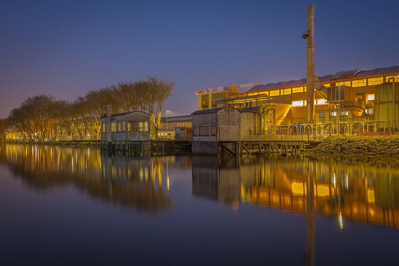 Illuminated factory by the river by Jan Georg Meijer