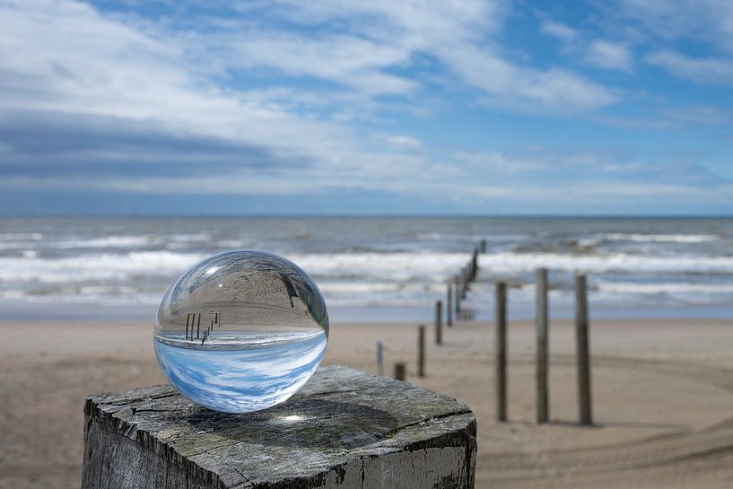 Lens ball on the North Sea beach by Peter Bartelings