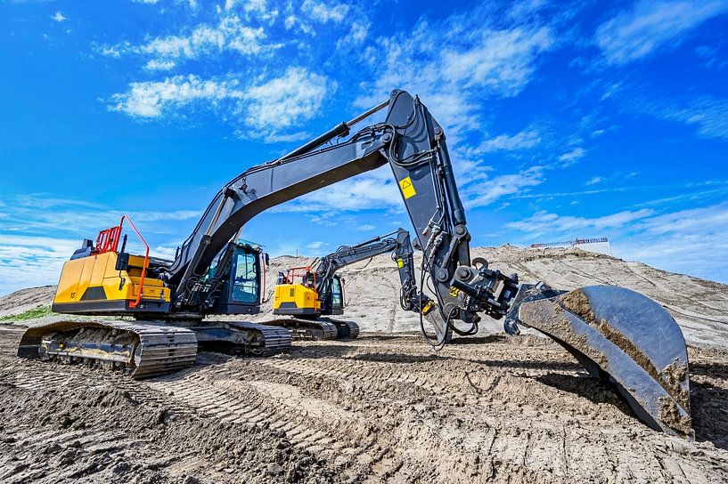 Graafmachine op een bouwplaats met een kleinere graafmachine van Sjoerd van der Wal Fotografie