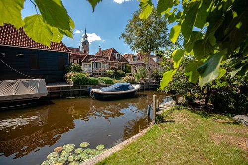 View of old canals with boats in an old Dutch town.