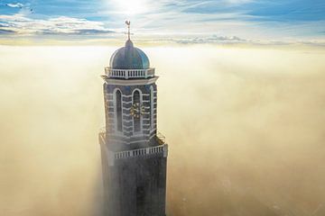 Peperbus church tower in Zwolle above the mist