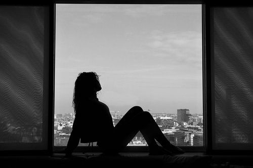 Silhouette of a woman in a window