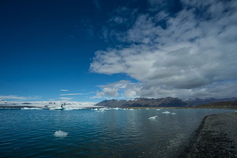 Iceland - Cloud front over glacial lake with black sand beach by adventure-photos
