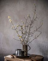 Still life with spring blossom and pewter beer mugs on wood