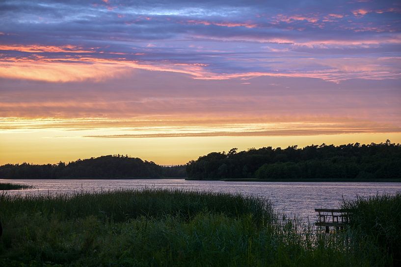 Evening sky with colored clouds after sunset over a lake landscape in northern Germany, copy space,  by Maren Winter