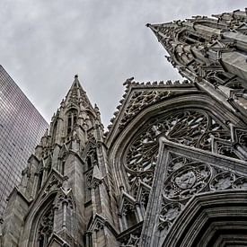 Blick auf die St. Patrick's Kathedrale in New York neben einem Wolkenkratzer. von John Duurkoop