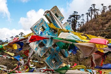 Colorful prayer flags hang over an Endless Knot (Buddhist symbol) in the valley near Bumthang, Bhuta by WorldWidePhotoWeb
