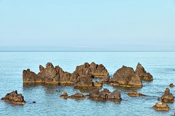 Rugged volcanic reefs in the open sea off Scalea