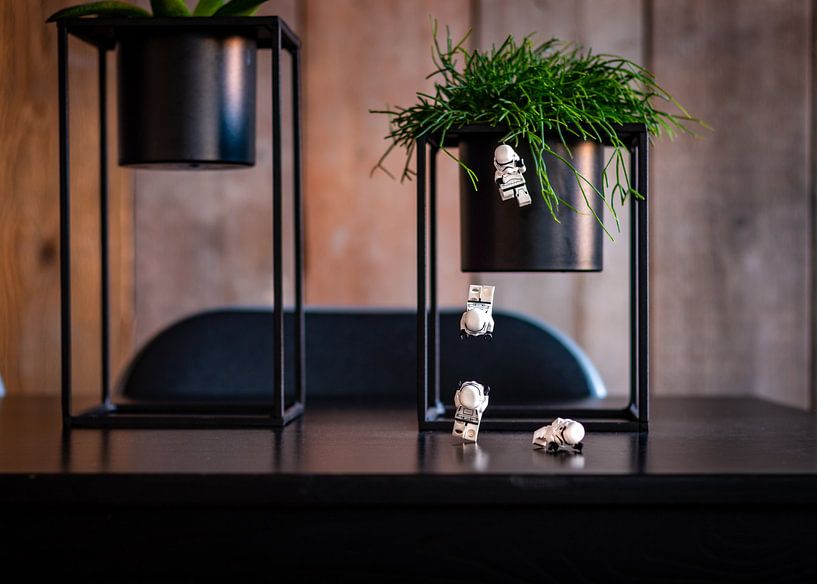 LEGO Star Wars Minifigures jump from a green plant to the table in an industrial interior von Raymond Voskamp