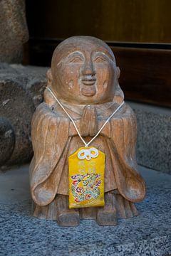 Stone Buddha figurine with a Japanese amulet by Frans Rombout