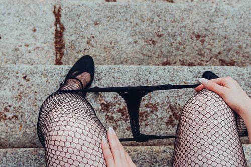 Wife sits in sexy black fishnet stockings and high heels with panties