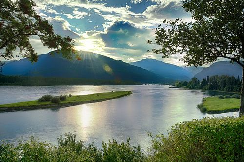Sun is setting behind the mountains and river
