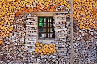 A pile of wood with a window