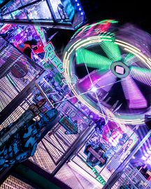 Circular motion – a carousel bathed in the colourful lights of the fairground by Mixed media vector arts