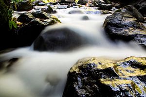 Rotsen onderaan de waterval op Lombok van Willem Vernes