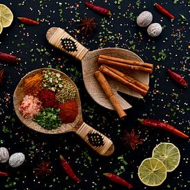 Herbs and spices on wooden salad spoons by Francis Dost