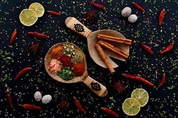 Herbs and spices on wooden salad spoons by Francis Dost