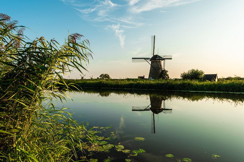 Childlike Windmill along the water. by Brian Morgan